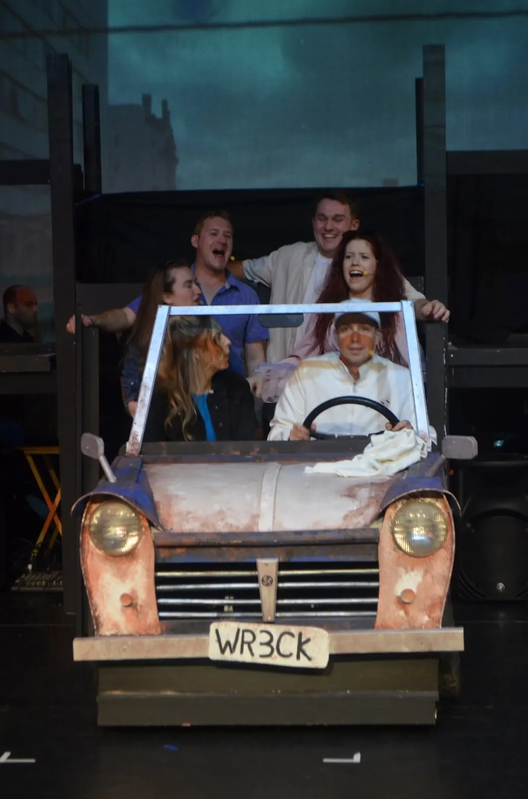 Performers riding in a stage car