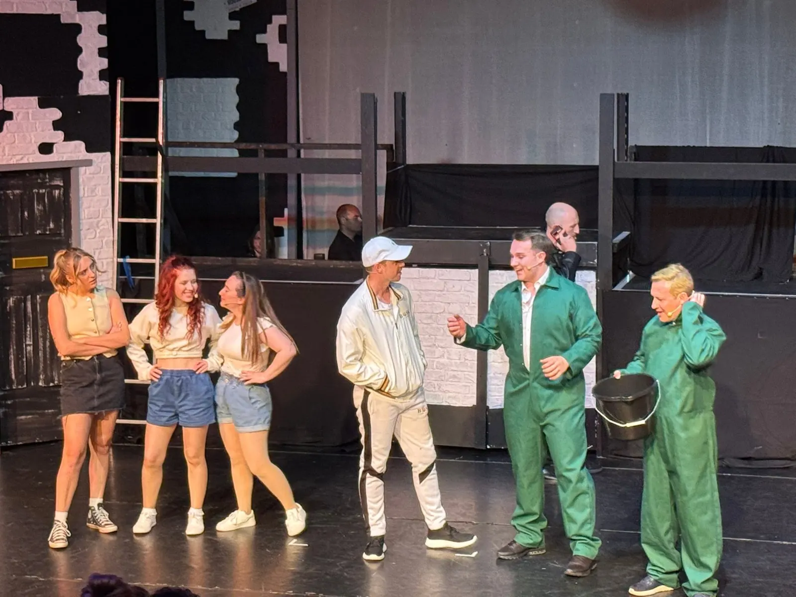 An ensemble scene in front of a street set